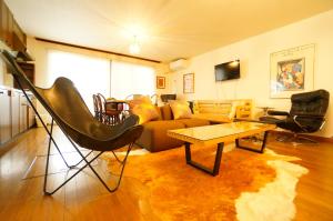 a living room with a couch and a table at Tomato Villa Takayama Station in Takayama