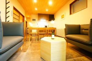 a living room with two couches and a table at Momiji Takayama in Takayama