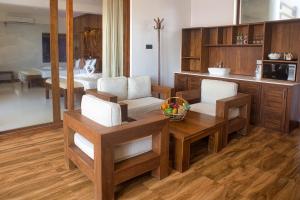a kitchen with wooden furniture and a table and chairs at Watergate Resort Unawatuna in Unawatuna