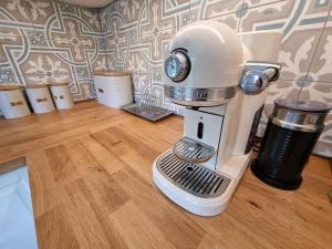 a white mixer sitting on top of a wooden floor at Akarana Cottage in Leura