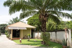 a palm tree in front of a house at ลีลา รีสอร์ท in Lam Luk Ka