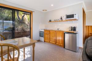 A kitchen or kitchenette at Driftwood Cottages, Waterfront Studios