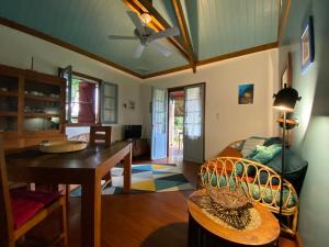a living room with a table and a dining room at Cana Suc in Sainte-Rose