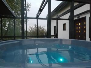 a large hot tub in the middle of a house at Trout Cottage 2 in Predeluţ