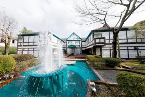 a fountain in a yard in front of a house at Kumamoto Hotel Christmas Forest Garden (Love Hotel) in Shimo-koga
