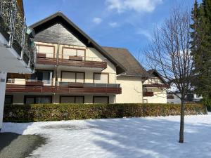 a house with snow in front of a building at Apart Inn Feldstrasse in Winterberg