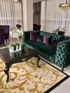 a living room with a green couch and purple pillows at Chernivtsi Arbat in Chernivtsi