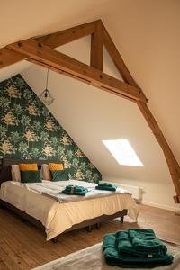 En eller flere senge i et værelse på Vakantiewoning Dorp-28