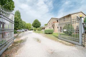 uma estrada velha com uma cerca em frente a uma casa em Casa Vacanze Vecchio Granaio em Magione