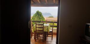 a room with a table and chairs on a balcony at Residence Spiaggia Bianca in Golfo Aranci