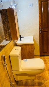 a bathroom with a toilet and a sink at Treehouse Tabor Hills Resort Vagamon in Vagamon