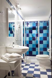 a bathroom with a sink and a toilet and a shower at Domu Elvira in Muravera