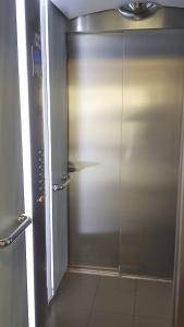 a shower stall with a glass door in a bathroom at 1 APPART 2 PIECES NEUF PROCHE GARE PARKING NETFLIX Evry Courcouronnes in Evry-Courcouronnes