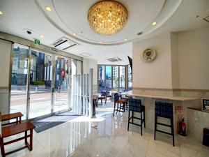 a lobby with tables and chairs and a chandelier at Akasaka Urban Hotel Annex in Tokyo
