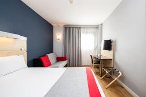 a hotel room with a bed and a desk at Holiday Inn Express Sant Cugat, an IHG Hotel in Sant Cugat del Vallès