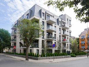 ein Apartmenthaus mit einem Metalldach auf einer Straße in der Unterkunft Lissa by Baltic Home in Świnoujście