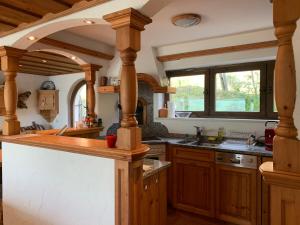 a large kitchen with wooden cabinets and a counter top at Ferienhaus Sonnleiten in Walchsee