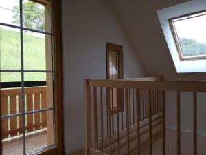 an attic room with a staircase and a window at Bioferienhaus Muster - Dominkusch in Pössnitz