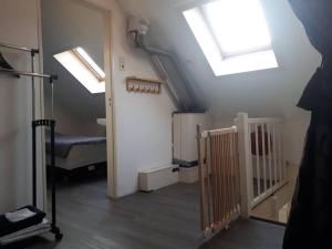 an attic room with skylights and a room with a bed at Huize Visser in Egmond aan Zee
