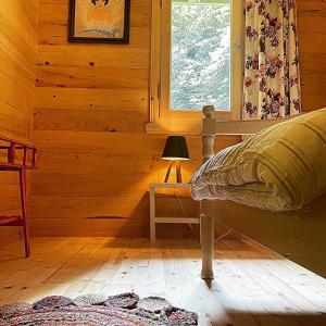 a bedroom with a bed and a window at Nanus Ayder Bungalow and Breakfast in Çamlıhemşin