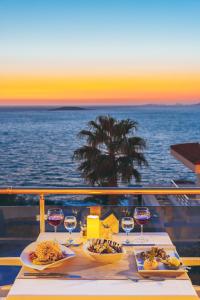 a table on a cruise ship with food and wine glasses at La Kumsal Hotel in Kaş
