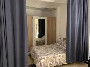 a bedroom with a bed and a mirror at Cévennes Bessegeoises in Bessèges +26 photos