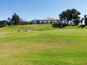 a group of people playing on a golf green at Vau Sea View, T2 Apartment, Close to Beach,Ideal for families in Portimão
