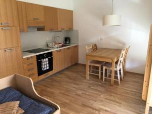 una piccola cucina con tavolo, tavolo e sedie di Apartma Runi pod Zlato lisico a Pekre