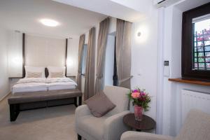 a room with a bed and a couch and a chair at House Klasika - Adults Only in Bled