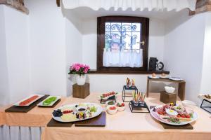 a dining room table with plates of food on it at House Klasika in Bled