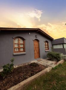 a house with two windows and a door at Casa Huellas de Malbec - Montaña y paz in Las Compuertas