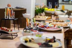 a buffet with many plates of food on a table at House Klasika - Adults Only in Bled