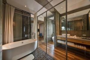 a bathroom with a bath tub and a sink at 觀日品月-渡假旅店 Meet Sun Moon Lake in Yuchi +50 photos