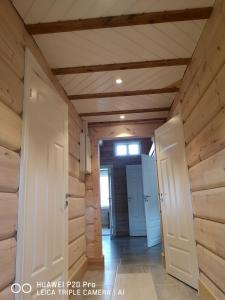 a hallway in a house with wooden walls and doors at Lyngen ski- og fiskecamp in Lenangsøyra