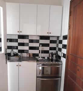 a kitchen with white cabinets and a stainless steel stove at Beauty in Saint-Jean-Cap-Ferrat