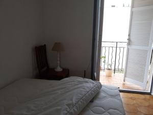 a bedroom with a bed and a window with a balcony at Beauty in Saint-Jean-Cap-Ferrat