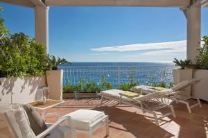 a patio with chairs and a table and a view of the ocean at Covo Dei Saraceni in Positano