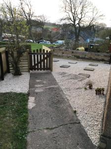 a wooden fence in a yard with two dogs at The Avenue in Eyemouth