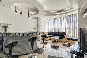 a living room with a couch and a table at Cozy Apartment in Most City Center in Dnipro