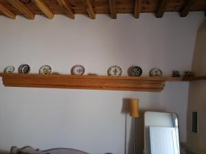 um quarto com uma prateleira com relógios na parede em Amphitrite Apartments Skyros em Skiros