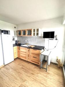 a kitchen with a sink and a refrigerator at Appartement Vue Mer 208 in Canet-en-Roussillon
