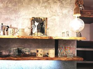 a wooden shelf with mugs and glasses on it at Studio Ray Town Centre - NO PARTY in Spišská Nová Ves