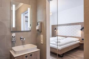 a bathroom with a sink and a mirror at Villa Flöckner Bed & Breakfast in Salzburg +137 photos