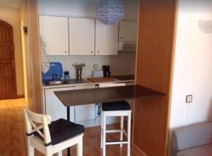 een keuken met een aanrecht en twee krukken erin bij STUDIO TAGORO in Costa Del Silencio +2 foto's