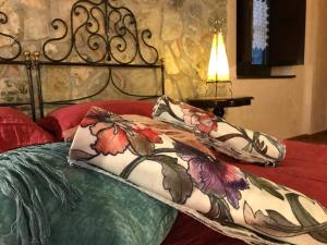 a bed with two pillows on top of it at Borgo Manca Suite in Sasso di Castalda