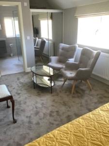 a living room with two chairs and a coffee table at The New Inn Halse in Taunton