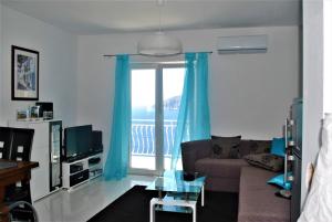 a living room with a couch and a sliding glass door at Villa Jagoda in Sveta Nedelja