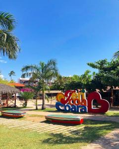 a sign for a beach with surfboards on the grass at Casa Jeri in Jericoacoara