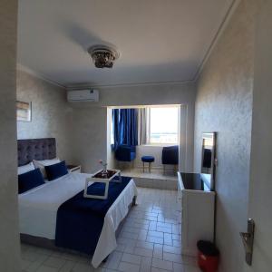 a bedroom with a bed and a living room at Panoramic Sea View Apartment 1 Min Walk to Beach in Tangier