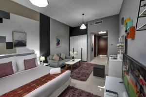 a living room with a bed and a couch at Kay Homes Royal Studio in Ras al Khaimah